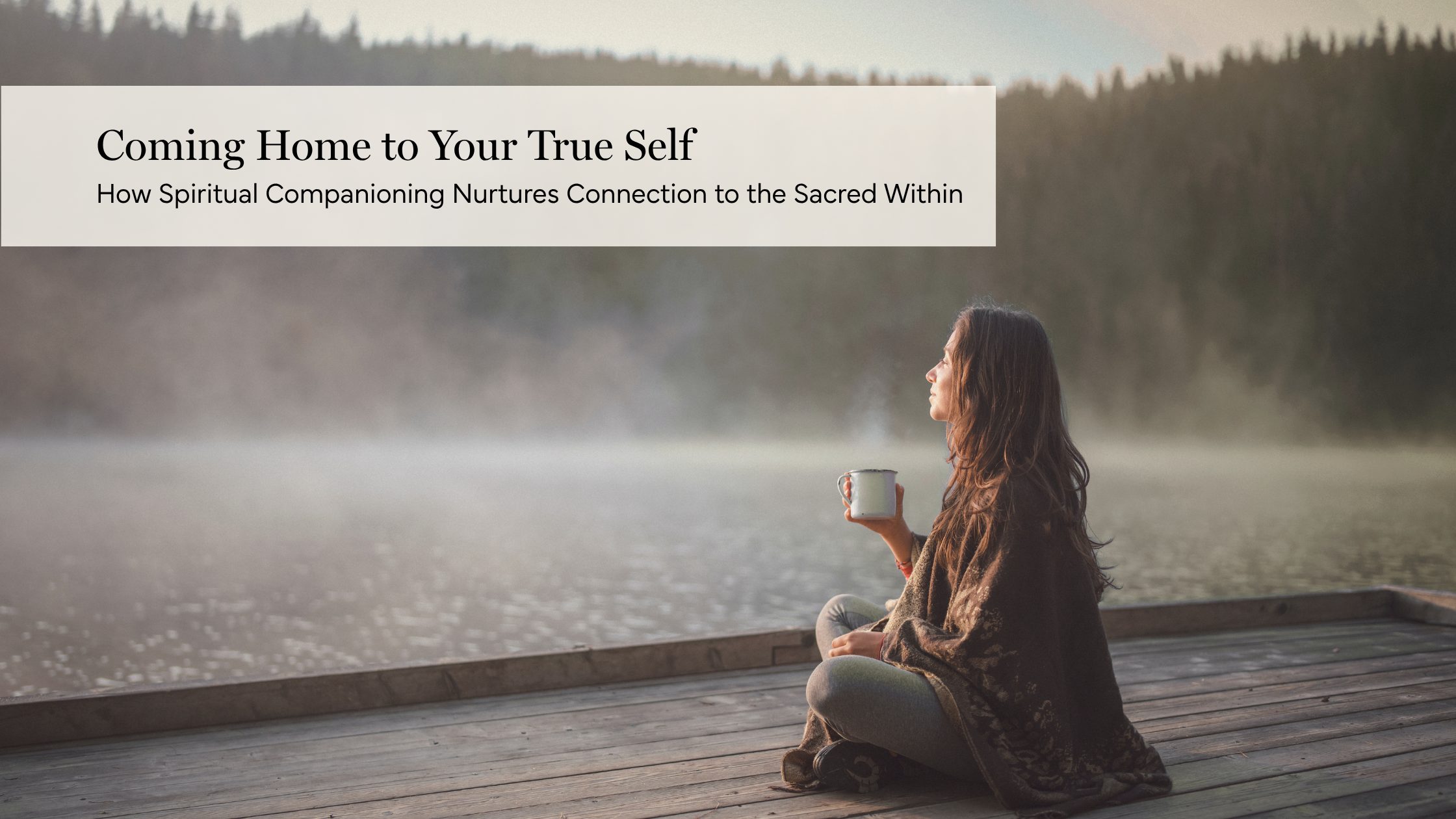 Woman sitting beside a misty lake in quiet reflection, representing spiritual companioning and coming home to the True Self.