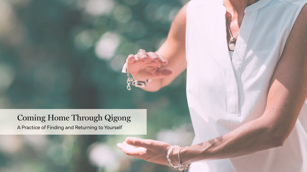Person practicing coming home to themselves through qigong outdoors, with hands held in front of the torso.